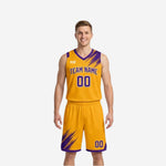 Custom reversible team basketball uniforms gold side front view with purple diagonal brush-stroke accents at shoulders and shorts legs, team name and number 00 printed in purple