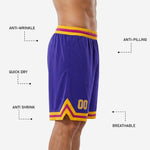 Close-up detail of the gold and magenta chevron trim at the hem of custom purple basketball shorts showing sublimation quality