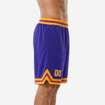 Side view of custom purple and gold basketball shorts showing chevron hem detail and elastic waistband with gold and magenta stripe