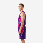 Side view of purple and pink sublimated basketball uniform set showing full pink lightning bolt graphic running down jersey and shorts