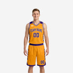 Front view of custom purple and gold reversible basketball uniform with arched team name, front number, and gold contrast V-neck binding