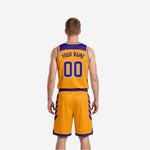 Other side view of custom purple reversible basketball jersey and shorts showing gold contrast trim and side-leg chevron detail