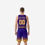 Side view of purple and gold reversible basketball uniform showing sleeveless jersey armhole binding and matching shorts with elastic waistband