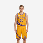 Gold side of the reversible basketball uniform showing purple diagonal stripe team name and number on gold jersey and shorts