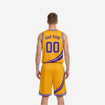 Gold side view of reversible basketball uniform showing purple and white collar binding and shorts waistband detail