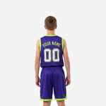 Opposite side view of custom purple youth basketball uniform sets displaying lime armhole binding shorts hem trim and sublimated number on shorts leg