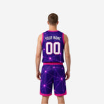 Purple and pink reversible basketball uniform side view showing V-neckline, armhole binding, and geometric sublimation pattern on jersey and shorts
