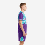 Side view left of purple teal crystal soccer kit showing full sublimation coverage on jersey and shorts