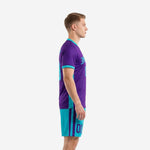 Custom purple soccer uniform side view showing turquoise side panels and turquoise shorts with purple stripe