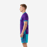 Royal purple soccer jersey with turquoise contrast cuffs and turquoise shorts, right side view on male model