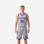 Custom purple and white reversible basketball uniform front view with team name and number on silver-white side