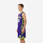 Purple youth basketball uniform side panel detail with bold neon green diagonal stripes running from jersey through shorts leg