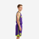 Custom youth team basketball uniforms in solid purple with neon lime green armhole and V-neck binding front number and arced team name on chest