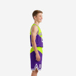 Front view of custom purple youth basketball uniform with V-neck jersey and lime diagonal panel worn by youth boy model