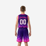Right side view of youth purple basketball jersey and shorts set showing pink hem band, side split, and flame graphic