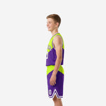 Side view of purple and lime youth basketball uniform set showing diagonal split on jersey and shorts with white armhole binding