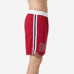 Side view of red custom basketball shorts showing full-length white and navy double side stripe and small hem split for range of motion
