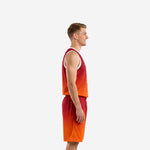 Side view of custom red and orange gradient basketball uniform set showing sleeveless jersey and matching shorts on adult male model