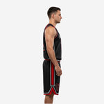 Front view of custom black and red sublimated basketball uniform with V-neck collar, red armhole binding, silver-gray team name arc, and red front number 77