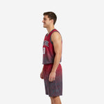 Opposite side view of red and black custom basketball uniform set showing sublimated diamond pattern on jersey and shorts