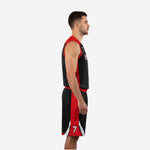 Side view of custom red and black basketball uniform showing red side panel on jersey and shorts with white chevron accent