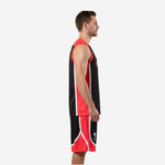 Side view of custom red and black basketball uniform showing red mesh side panels on jersey and shorts with white contrast trim