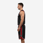 Side view of black and red basketball uniform set showing red side panel on jersey and matching red side stripe running down the shorts leg