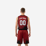 Opposite side view of men's red and black basketball uniform set showing elastic waistband, drawcord on the shorts, and side split hem detail