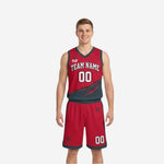 Custom red and black reversible basketball uniforms front view showing red side with charcoal diagonal claw-scratch panel and white team name and number