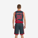 Opposite side view of the custom reversible basketball uniform showing the charcoal-dominant jersey and matching reversible shorts with red side panel