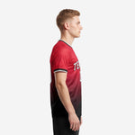Red and black soccer jersey showing full gradient from shoulder to hem with white contrast sleeve cuff stripe, left side view