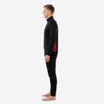 Right side view of the custom red and black soccer tracksuit showing the tapered pant cut and ribbed ankle cuff