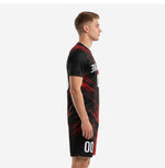 Side view of custom red and black soccer uniform showing diagonal red slash lines across jet black jersey and shorts