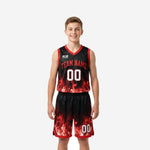 Red and black youth basketball uniforms with full-sublimated flame graphic on jersey and matching shorts, front view, youth boy model