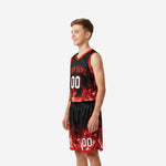 Right-side view of black and red youth basketball uniform showing red armhole binding and flame design on shorts