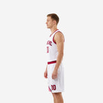 Opposite side view of red and white sublimated basketball uniform set with navy accent stripe along curved crimson panel