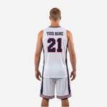 Left-side view of white sublimated basketball uniform set with red-and-navy trim stripe on shorts hem