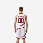 Opposite side view of white reversible basketball uniform displaying black and crimson swirl trim on jersey and shorts