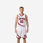 White side of reversible basketball uniform with crimson swirl panel, crimson team name arc, and matching white shorts with swirl detail