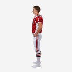 Front view of custom red and white youth football uniform with crew collar stripe trim and white mesh side panels on red jersey