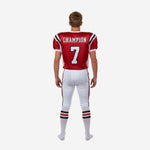 Left side view of red and white youth American football uniform showing white mesh panel on jersey and red black side stripe on pants