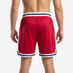 Back view of custom red basketball shorts with navy and white chevron hem stripe and sublimated player number
