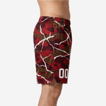Side view of custom red basketball shorts showing camo crackle pattern and mid-thigh length on adult male model