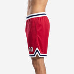 Opposite side view of custom red basketball shorts displaying solid red polyester shell and elastic drawcord waistband
