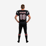 Back view of custom youth football uniform in black and red showing back number, nameplate area, and silver pant side panel construction