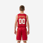 Side view of red and gold youth basketball uniform showing gold geometric triangle pattern along jersey and shorts outer panels