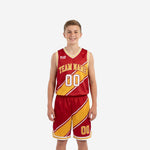 Custom red and gold youth tournament basketball uniforms with diagonal stripe panel shown front and back on youth boy model