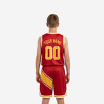 Right side view of custom red and gold youth basketball uniform set showing matching diagonal stripe on jersey and shorts