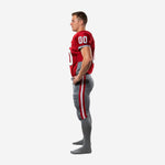 Left side view of red and gray sublimated football uniform showing sleeve trim detail and full-length gray pants construction