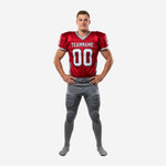 Red and gray youth football uniforms front view showing V-neck jersey with white team name and number 00 plus matching gray pants with red double leg stripe